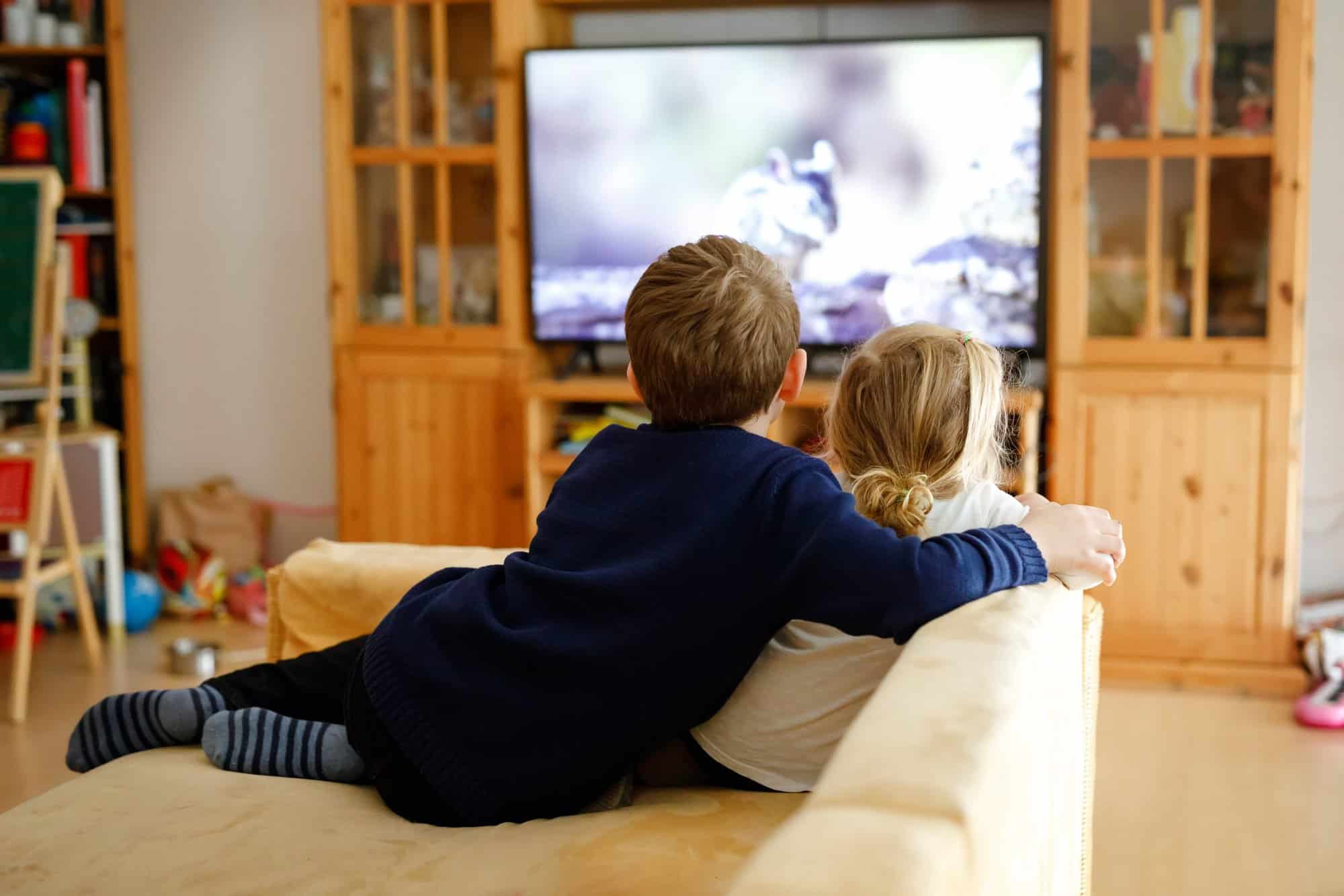 Cute Little Toddler Girl And School Kid Boy Watching Animal Movi