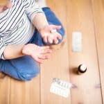 Little Toddler Playing With Pills. Domestic Accident. Dangerous Situation At Home. Top View.