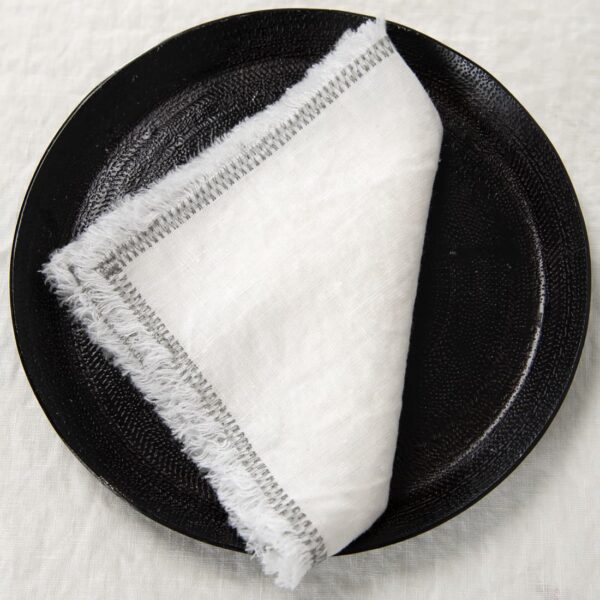 white linen napkin with decorative stitch.