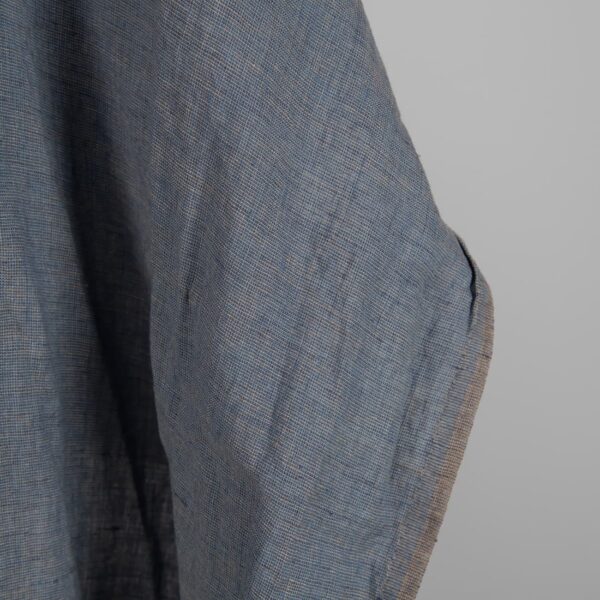 Linen Fabric Brownish Blue Color Washed for sewing clothes and home textiles close up edge view