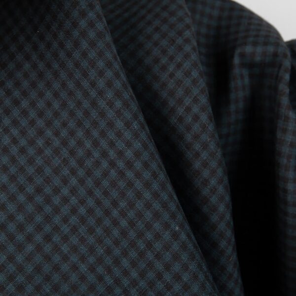 Dark linen fabric in black and blue checks close up detail view
