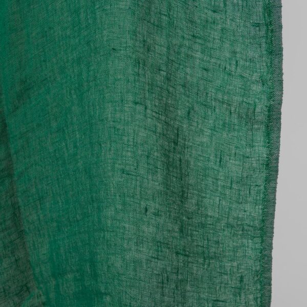 Washed linen fabric emerald green transparent close up edge view