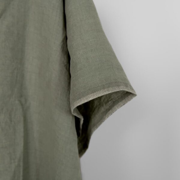 Washed linen fabric greyish green melange, fabric edge