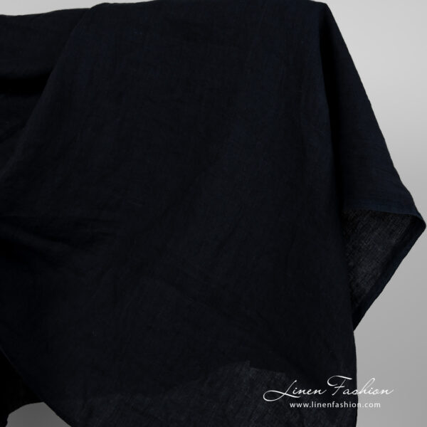 Wide washed linen fabric blueish black colour close edge view