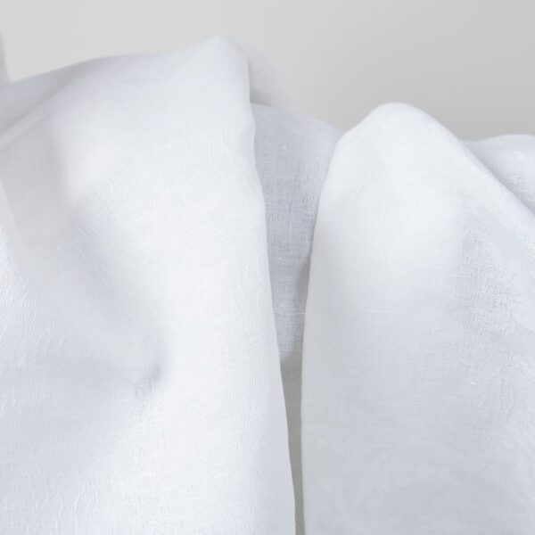 Optical white linen cotton fabric with flower ornaments texture