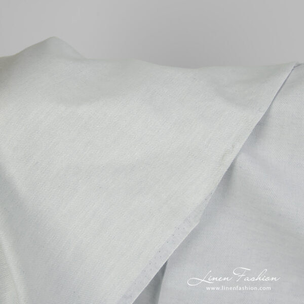 Linen cotton fabric blueish green twill weave close up detail