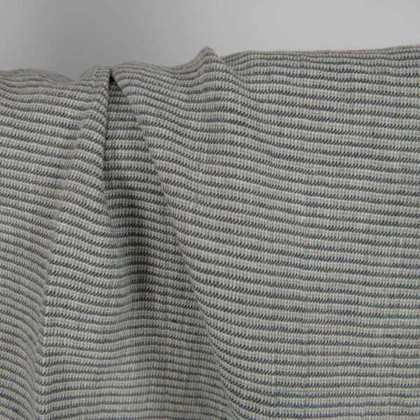 Washed linen fabric green-grey small pattern close up detail