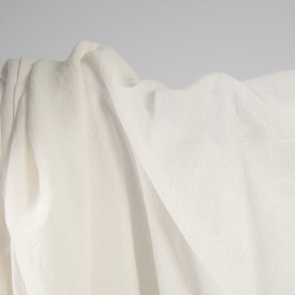 Wide washed linen cotton fabric off-white colour close up detail