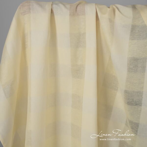 Pale yellow linen cotton fabric with stripes.