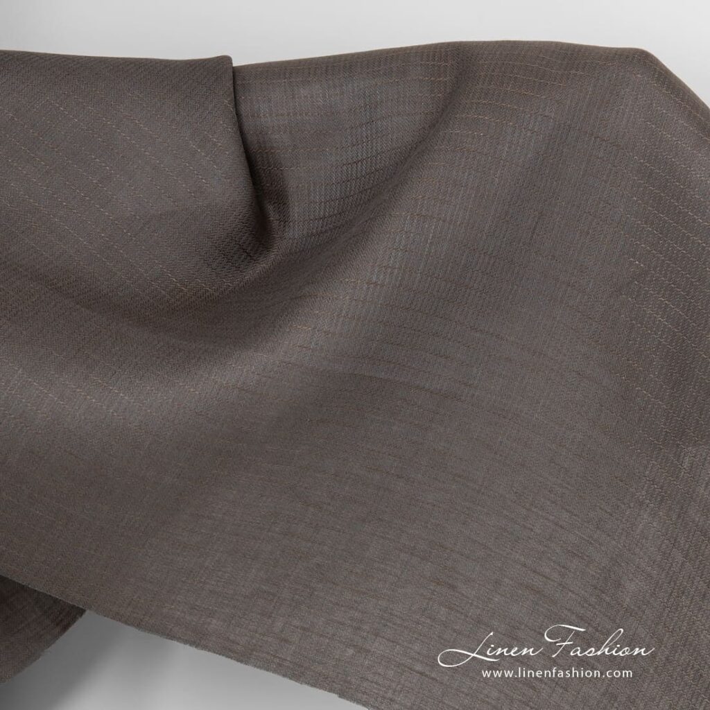 Tissu en lin gris brun à chevrons 1 Grey brown linen fabric in herringbone pattern.