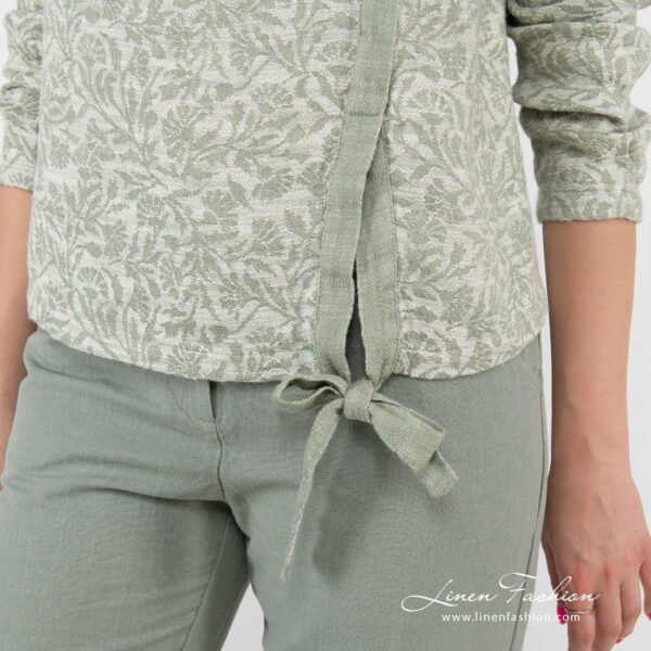 green flower blouse with knotted ribbom at bottom.