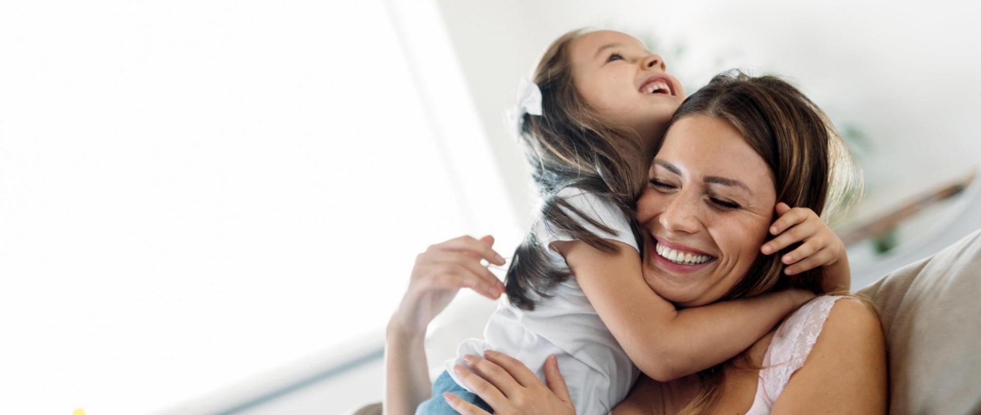 Mother and daughter healthy and happy on sofa