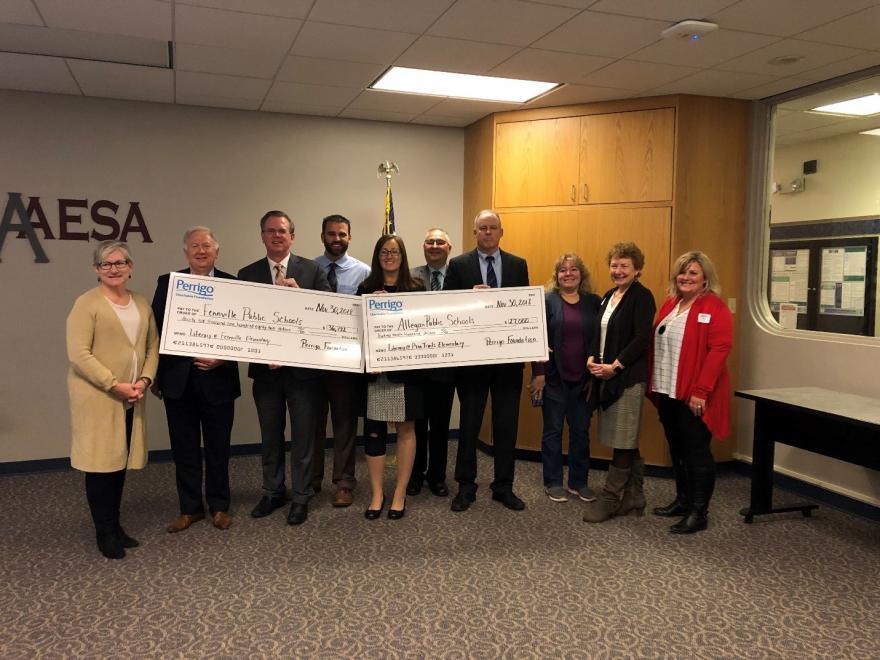 Perrigo_staff_presenting_check.jpg