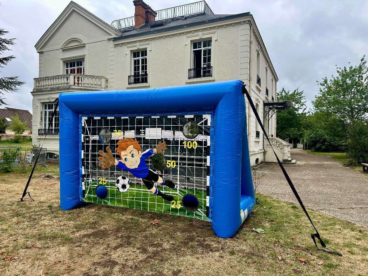 photo d'une cage de football bleu gonflable bleu avec 5 trou et un gardien qui plonge