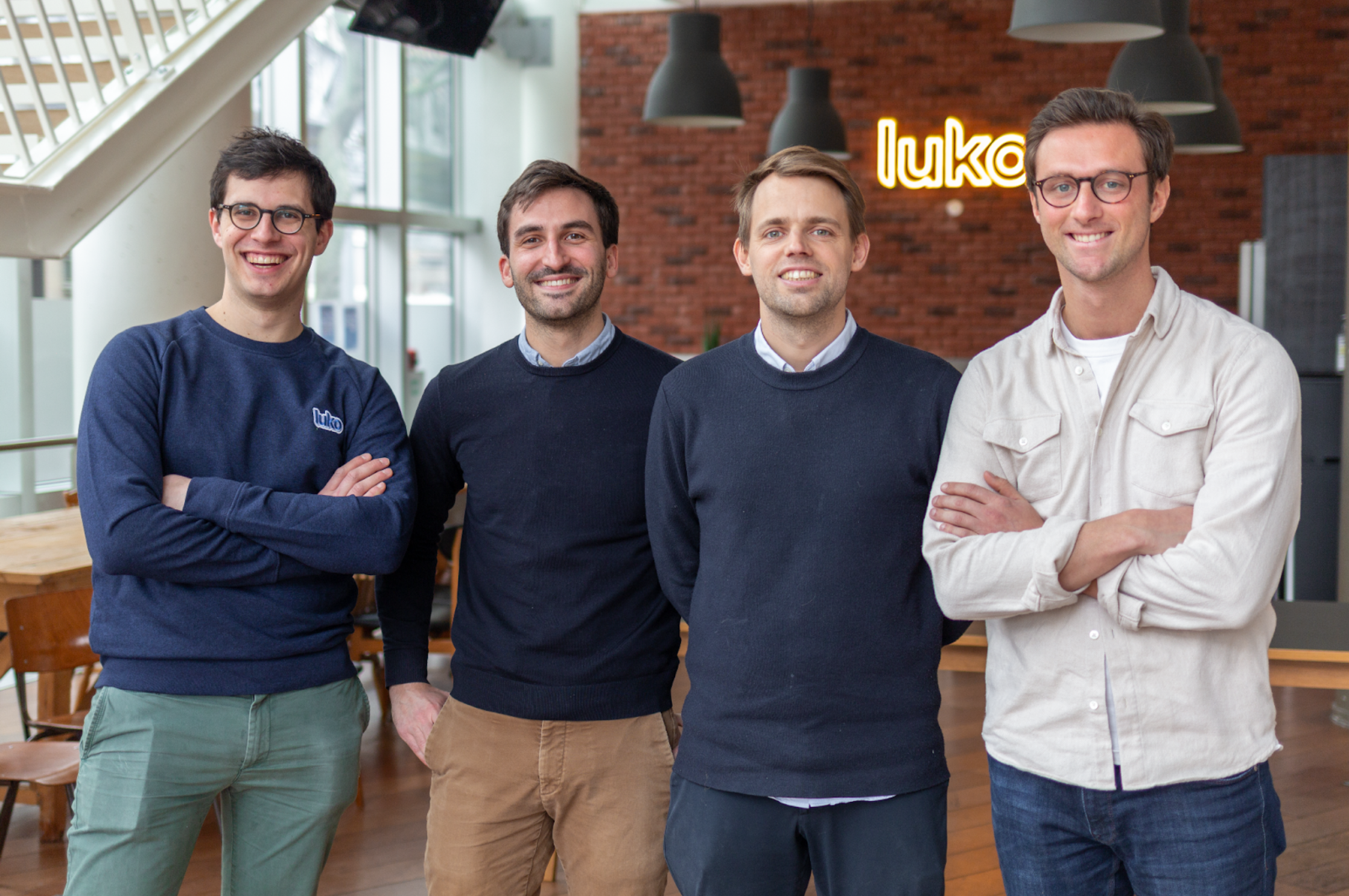 Four people at Luko’s office in the 2022 Unkle acquisition announcement